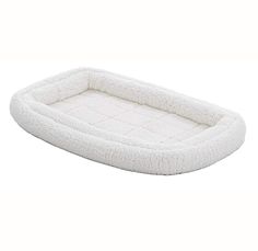 a white dog bed that is made out of fleey material and has a long, rectangular