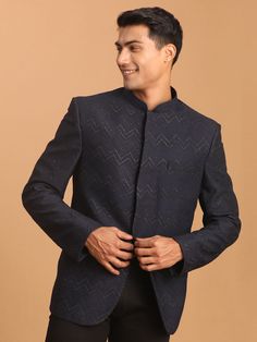 Men's Navy Blue Silk Blend Glitter Zig Zag Jodhpuri Look dapper in this luxurious navy blue Jodhpuri featuring a shimmering zig zag glitter pattern. Crafted from a silk blend, this piece offers a comfortable and stylish fit. Key Features Navy blue silk blend with zig zag glitter work Mandarin collar Full sleeves Welt pocket with pocket square Specifications Sleeve Length - Full sleeves Neck - Mandarin Collar Jacket fabric - Silk blend Pattern - Glitter work Material & Care Silk Blend Dry Clean p Festive Nehru Jacket For Groom, Semi-formal Diwali Nehru Jacket, Designer Sherwani For Party, Winter Blue Bandhgala For Formal Events, Designer Traditional Wear For Formal Winter Occasions, Blue Nehru Jacket For Semi-formal Occasions, Blue Formal Kurta For Winter, Festive Party Wear Sherwani For Groom, Semi-formal Bandhgala With Zari Work For Winter