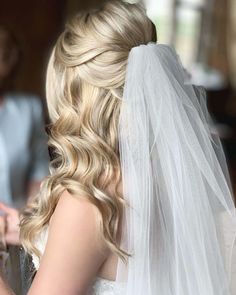 the bride is getting ready to walk down the aisle in her wedding dress and veil