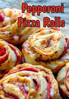 several small pizza rolls with pepperoni and cheese in them on a wooden surface, text overlay reads peperoni pizza rolls