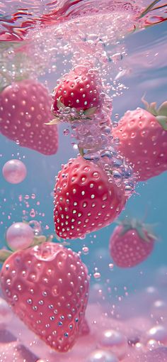 some strawberries are floating in the water and being submerged by bubbles on top of them