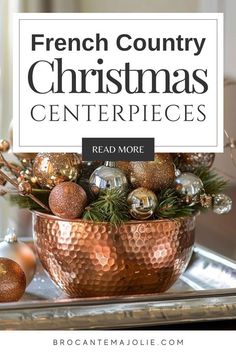 a copper bowl filled with christmas ornaments on top of a metal tray, and the words french country christmas centerpieces read more