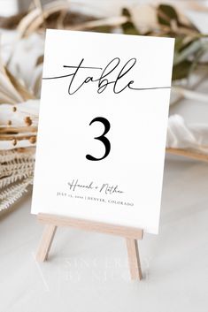 a table number is displayed on an easel