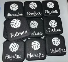 six black and white volleyball coasters with the names of different teams on them, sitting on a table