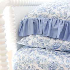 blue and white bedding with ruffled pillows