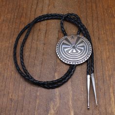 Sterling silver cast Man in the Maze bolo tie. This bolo is 2 5/16" diameter. The back is stamped STERLING R. The cord is 45" long including the 2 1/8" long sterling silver tips. The Man in the Maze design is used by several Native American tribes. The Tohono O'Odham claim it as their tribal symbol. It has to do with working through life's trials before going to a final resting place. This bolo is in good condition. Thank you for shopping in our store. Please let us know if you have questions. B Artisan Silver Lariat Bolo Tie, Silver Lariat Bolo Tie With Adjustable Length, Silver Lariat Bolo Ties With Adjustable Length, Adjustable Sterling Silver Lariat Bolo Tie, Southwestern Sterling Silver Bolo Tie, Southwestern Style Sterling Silver Bolo Tie, Western Silver Bolo Tie With Sliding Knot, Artisan Silver Bolo Tie With Concho, Western Silver Lariat Bolo Ties