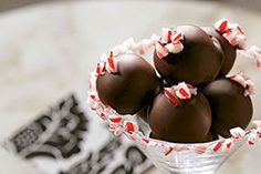 chocolate covered candies in a glass vase on a table