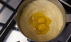 two eggs are being cooked in a pot on the stove