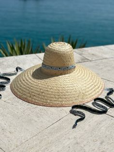 The extra-wide brim sun hat is woven, like a basket, with dried palm tree leaves. Then it is shaped with the same antique hat mold we use to shape our Daisy sun hat.  This super wide-brimmed hat will glamorously shield you from the sun. The Geranium is woven with wider pieces of palm leaf vs. The Daisy is woven with fi Artisan Curved Brim Sun Hat For Summer, Artisan Sun Hat With Curved Brim For Summer, Artisan Summer Sun Hat With Curved Brim, Palm Leaf Hat Bands For Beach Spring Season, Artisan Brimmed Sun Hat For Summer, Artisan Hat Bands For Summer Vacation, Artisan Beach Hat Bands For Spring, Artisan Hats For Beach And Kentucky Derby, Artisan Sun Hat With Curved Brim For Beach