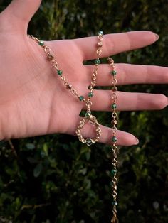 Handmade necklace in gold-toned tarnish resistant copper wire and green beads. Alternating green and gold beads end in a handmade swirling pendant. 17 1/2 inches, adjustable.  Made with 20 gauge wire. While generally sturdy, as with all wire jewelry, there is potential for the wire to be bent, so please handle with care. Bohemian Style Gold Emerald Necklace With Round Beads, Bohemian Gold Emerald Necklace With Round Beads, Gold Necklace With Hand Wrapped Round Beads, Gold Wire Wrapped Metal Beaded Necklaces, Gold Wire Wrapped Beaded Necklaces, Green Copper Hand Wrapped Necklaces, Green Hand Wrapped Adjustable Necklace, Gold Wire Wrapped Metal Beaded Necklace, Gold Metal Wire Wrapped Beaded Necklace