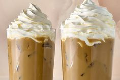 two tall glasses filled with whipped cream on top of each other