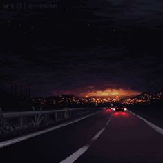 a car driving down the road at night with fire in the sky and trees on either side