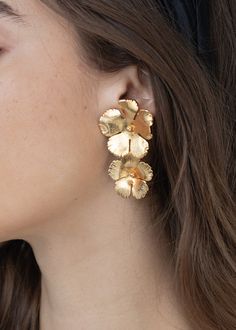 The Collette Earring is a staple in the Jennifer Behr collection, and it's no wonder why: these golden blooms offer versatility and femininity. The shape and arrangement is inspired by Andy Warhol's iconic flower series, and this earring offers the same mood-boost as the Pop Art paintings. Dimensions: 2.25 x 1.5 inches Weight: 9.5g each Petal-shaped Jewelry With Matching Earrings, Elegant Yellow Gold Clip-on Flower Earrings, Gold Luxury Drop Flower Earrings, Elegant Gold-plated Flower Charm Earrings, Gold Plated Flower Earrings For Formal Occasions, Formal Gold Plated Flower Earrings, Yellow Gold Flower Earrings For Party, Delicate Gold Clip-on Earrings, Gold Flower Drop Earrings For Evening