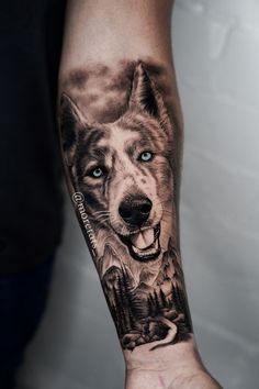 a man's arm with a wolf tattoo on it, and an image of mountains