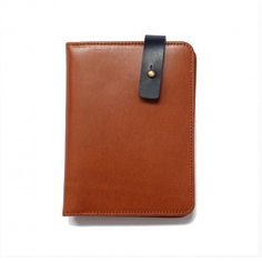 a brown and black leather case with a clip on the front, sitting against a white background