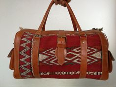 A beautiful Moroccan large weekender bag. very large and fits all important things and more made of leather and vintage Klim rug Inner slip pocket plus zippered pocket. Zip main compartment closure with buckled leather strap for additional style and security. Leather base, sides with buckle closure end pockets, and riveted handles. Measures: L(53) Cm x H(28) Cm x W(27) Cm L(20.6) inch x H(11) inch x W(10) inch I am happy to answer any questions Traditional Rectangular Weekender Bag For Travel, Traditional Rectangular Duffle Bag For Travel, Bohemian Leather Tote Travel Bag, Traditional Tote Travel Bag With Leather Handles, Bohemian Rectangular Bag For Overnight Trips, Traditional Tote Weekender Bag For Travel, Traditional Travel Tote Bag With Leather Handles, Traditional Satchel For Travel, Bohemian Leather Tote Duffle Bag