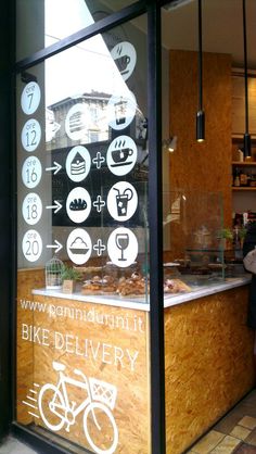 there is a sign on the window that says bike delivery and it's written in white