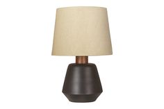 a table lamp with a brown base and a beige shade on the top, against a white background