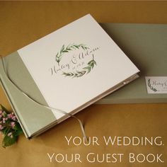 the wedding guest book is next to a flower