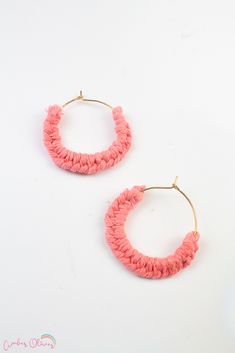 the pink hoop earrings are made from yarn