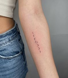 a woman's arm with the phases of her moon tattoo on its left side