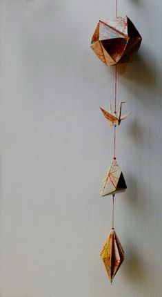 an origami bird hanging from a string