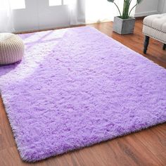 a purple rug on the floor in a living room