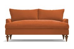 an orange couch sitting on top of a white floor