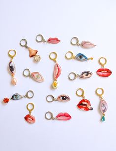 a collection of assorted charms with eyes and lips on them, all in different colors