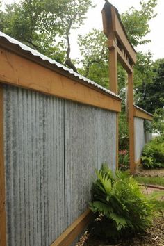 a small wooden building sitting next to a lush green forest