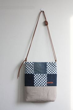 a purse hanging on the wall with a cord