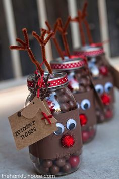 three jars filled with chocolate covered candies and reindeer noses, tied to brown paper tags