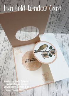 a card with a bird on it and some flowers in the box next to it