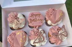 pink and white cupcakes in a box with happy birthday written on them