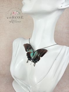 Light up your outfit with this stunning Papilio Ulysses butterfly necklace, made of soft natural silk.  Both trendy and timeless, it's great for creating an impressive appearance and it's easy to match with almost anything. This statement butterfly necklace captures the magic of nature and is an outfit changer and a real eye-catcher. Looks gorgeous with anything! It is comfortable to wear and designed for everyday wearing or special occasion. Product specifications:     * butterfly sizes 7 x 5 cm;     * necklace length 48 cm;     * the butterfly has three layers of silk;     * realistic look;     * light and translucent. The butterflies are printed on silk, each butterfly is carefully hand cut and the edges are gently sealed to prevent the fabric from fraying. Important! Please read the FA Papilio Ulysses, Ulysses Butterfly, Gothic Gifts, Style Gothic, Pendant With Chain, Halloween Accessories, Butterfly Charm, Natural Silk, Butterfly Necklace