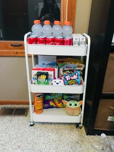 a white cart filled with drinks and snacks