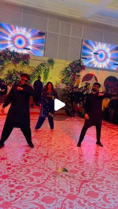 two people dancing on a dance floor with lights in the background