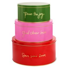 four different colored tins with writing on the sides and one saying, pass the joy