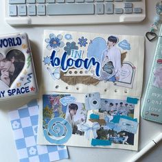 an assortment of stickers and magnets sitting on a desk next to a keyboard