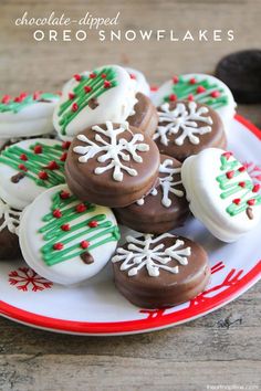 chocolate covered cookies decorated with white and green icing on a plate next to candy canes