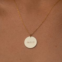 "Think of the statement that you wish to make as our 14K gold filled disc is large enough to engrave up to 9 letters - so you can opt for a name, initials, or even a word that holds great meaning for you. Simple and uncomplicated, the shiny-finish pendant hangs from a delicate chain in matching gold that comes in your choice of 16, 18, or 20-inch lengths. Free Engraving for a limited time! NECKLACE DETAILS * 14k gold-filled disc and chain. * Chain in your choice of 16\", 18\", or 20\" length * D Stamped 14k Gold Round Necklace, Gold Minimalist Jewelry With Laser Engraving, Gold Laser Engraved Wedding Jewelry, Minimalist Round Laser Engraved Jewelry, Minimalist Gold Necklace With Laser Engraving, Gold Laser Engraved Necklaces For Anniversary, Gold Laser Engraved Necklace For Anniversary, Gold Laser Engraved Jewelry For Anniversary Gift, Gold Laser Engraved Jewelry For Anniversary