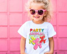 Elevate your little one's birthday celebration with our "Kids Party Animal Balloon" Birthday Graphic Tee! This shirt isn't just clothing; it's a vibrant expression of the excitement that birthdays bring. Crafted for the party animals and balloon enthusiasts, this tee features playful graphics that capture the joy of special occasions. Perfect for birthday parties or everyday festivities, it adds a whimsical touch to your child's wardrobe. Let their style reflect the festive spirit with our "Kids Party Animal Balloon" Birthday Graphic Tee - because birthdays are all about fun, and this tee ensures your little one is ready to party in style! .: 100% Airlume combed and ring-spun cotton (fiber content may vary for different colors) .: Extra light fabric (4.2 oz/yd² (142 g/m .: Retail fit .: Te Balloon Animals, Balloon Design, Animal Party, Birthday Balloons, Kids Tops, Kids Party, Light Fabric, Halloween Shopping, Balloons