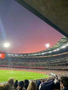 a stadium filled with lots of people watching a baseball game