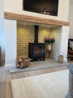 a living room with a fireplace and television mounted above the fire place on the wall