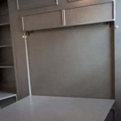 an empty room with shelves and cupboards in it