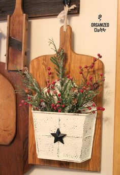 a potted plant hanging on the wall next to a cutting board with a knife