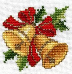 a cross stitch christmas ornament with bells and holly