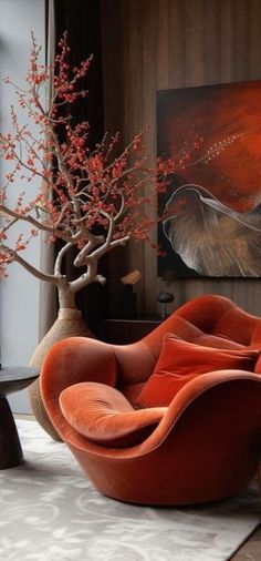 an orange chair sitting on top of a rug next to a vase filled with flowers