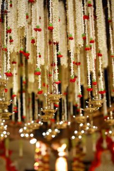 the chandelier is decorated with white and red flowers