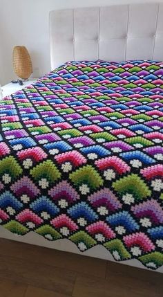 a crocheted bedspread on a bed in a bedroom